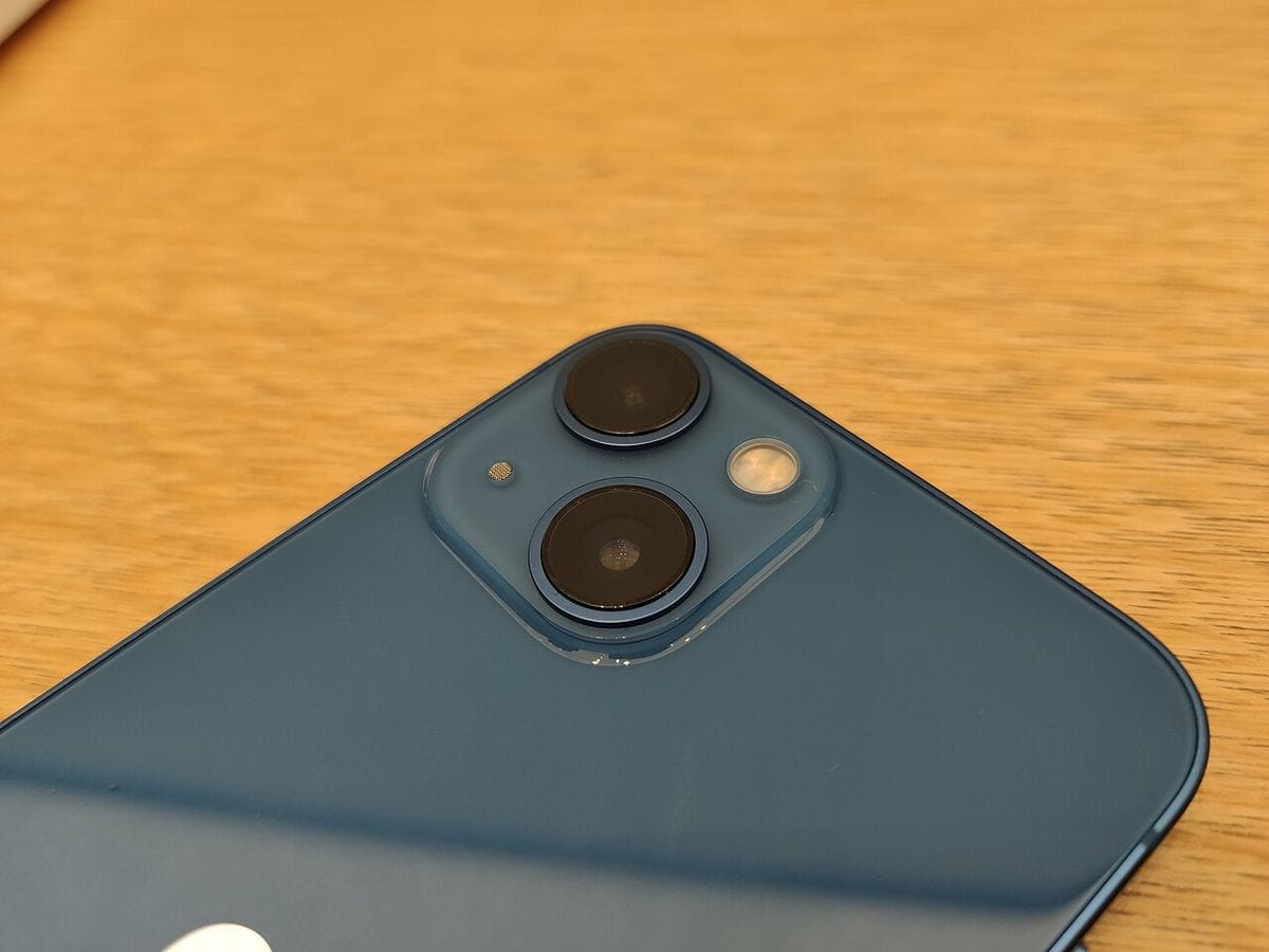 iPhone 13のデュアルカメラレンズのクローズアップ。対角配置の2眼レンズとフラッシュ・マイクが写る